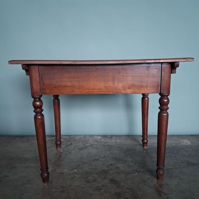 An authentic antique table from the Wilhelminian era with a warm, dark finish and a beautiful, serene presence. Its clean...