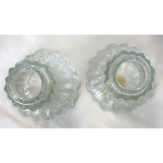 Timeless pair of large salt and pepper shakers from the mid 20th century. They are made of heavy fluted glass with a...