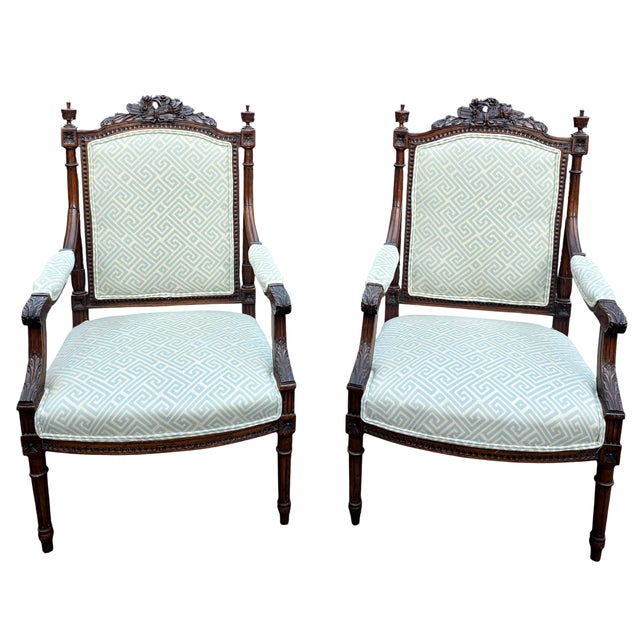 This Pair of antique French Louis XVI–style Hand-CArved Armchairs has classical detailing that gives them a refined...