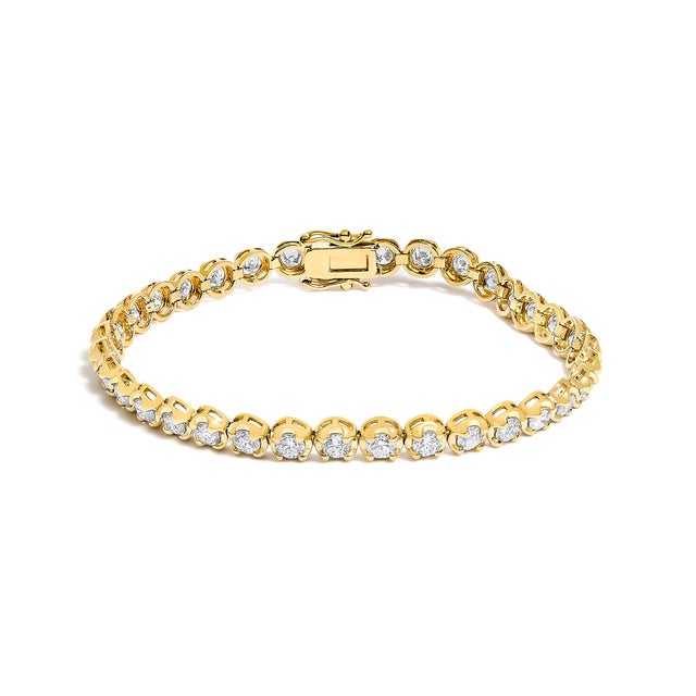 Immerse yourself in the splendor of timeless elegance with this 14K yellow gold tennis bracelet. Each scalloped link...
