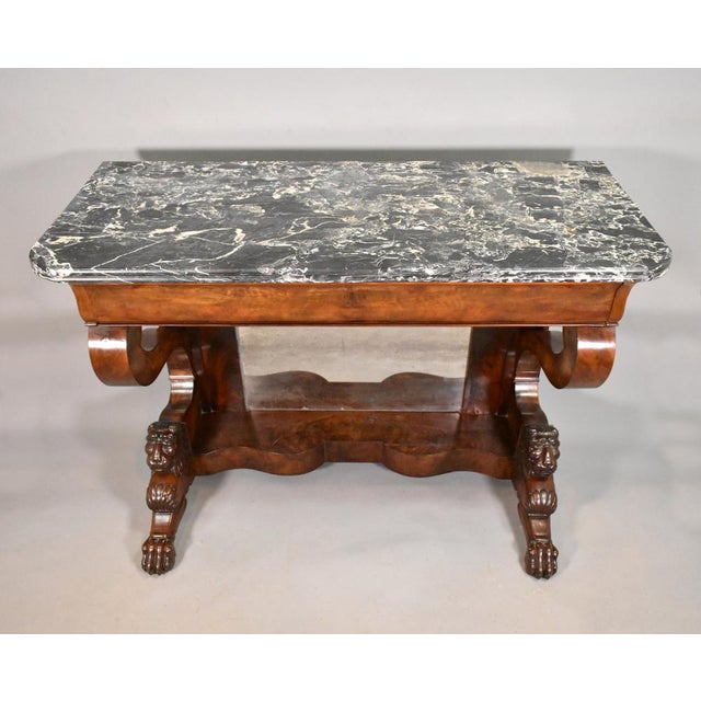 This impressive console table features a variegated black, white and grey Brèche marble top with a moulded outer edge....