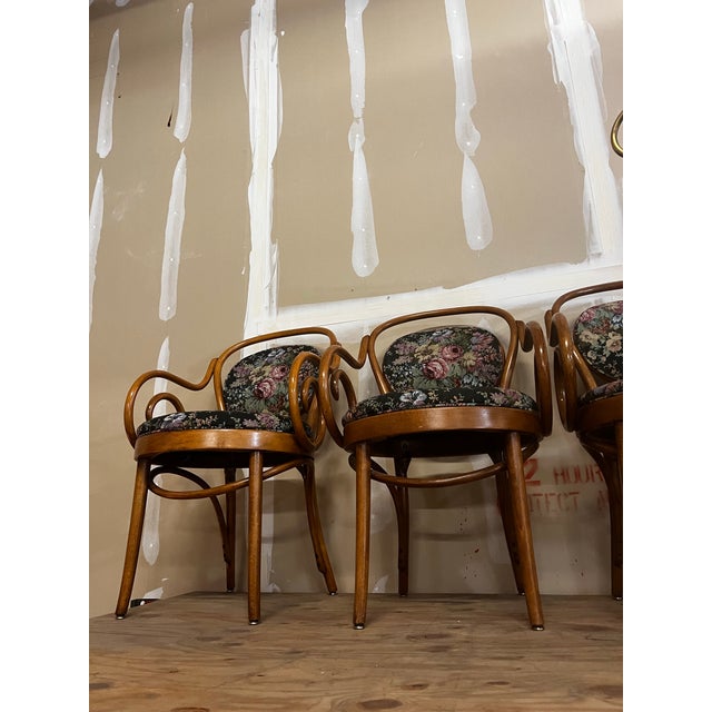Up for consideration is a beautiful vintage collection of floral cushioned bentwood looped arms dining chairs. These would...