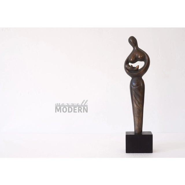 Stunning vintage mid century abstract brass Madonna and Child sculpture on a black wooden base. Beautiful patina on the...