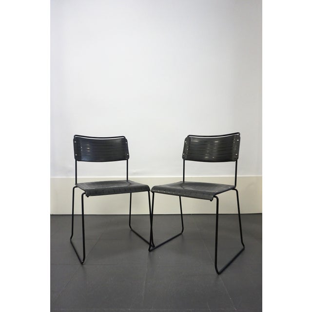 Pair of Italian chairs from the 1980s, manufactured by Spilimbergo. The frame is black metal, and the seat and backrest...