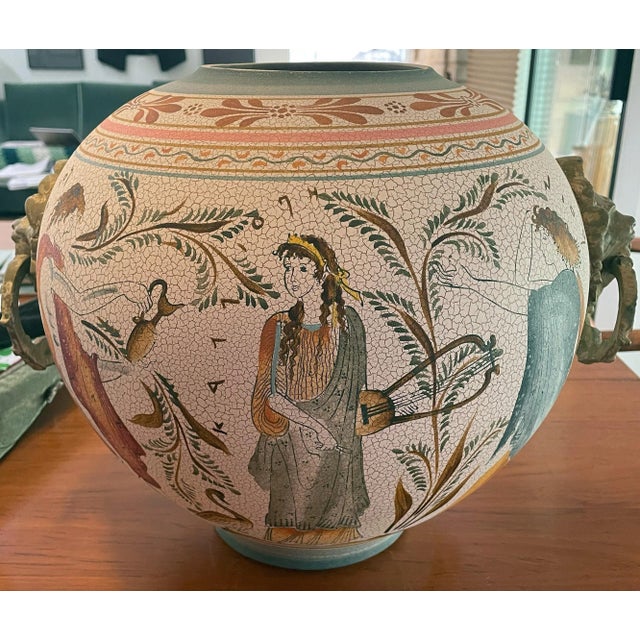 This beautiful white backgrounded reproduction of a Greek vase with a polychromed design would be beautiful in any...