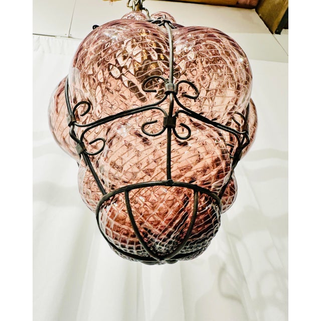 Hand-blown Murano glass in a smoky rose-amethyst, threaded with fine white filigrana stripes and pressed through a hand-...