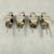 A set of four extremely scarce and unusual sterling silver lemon slice squeezers, Birmingham, England, date marked 1909....