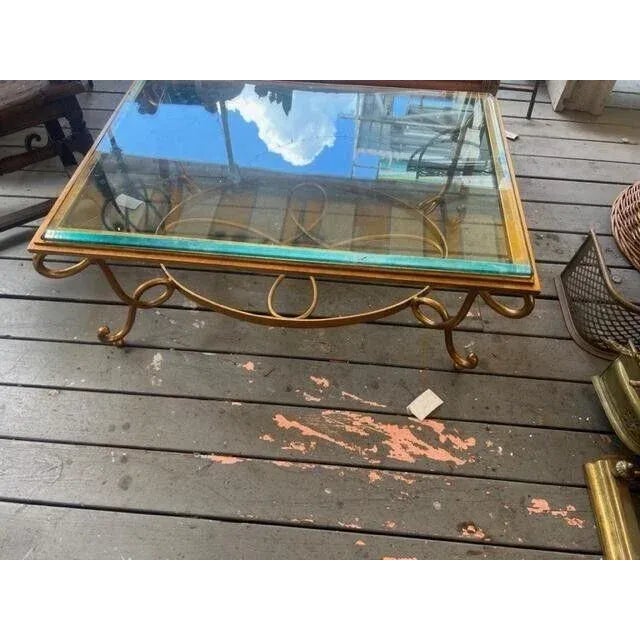 This is a very nice heavy duty metal gold colored coffee table with a plate glass top. circa 1970 measurements are 40 long...