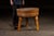 A solid round butcher block table with hand-turned legs and a thick end-grain maple top. The surface shows concentric...