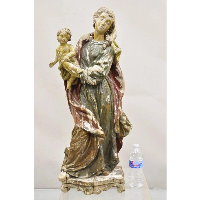 Antique Spanish Latin Polychromed Carved Wood Figure Madonna and Child Statue. Item features a tall impressive form, hand...