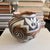 Vintage hand-painted pottery vase marked “Acoma, N. Mex.” on the underside. The rounded olla-style form features bold...