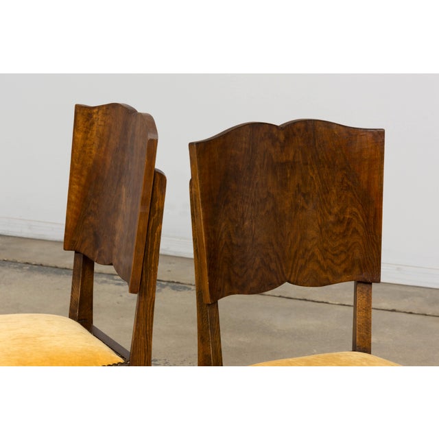 1930s French Art Deco dining chairs, sourced in Provence, France. The pair features distinctive sculpted mustache-back...
