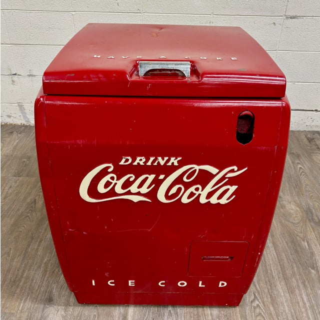 This is an authentic and rare vintage Westinghouse Coca-Cola bottle cooler, circa 1940s, featuring iconic raised “Drink...