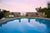 Sunset By The Pool by Toni Frissell People watch the sunset over the ocean while standing by a swimming pool, 1962 (Photo...