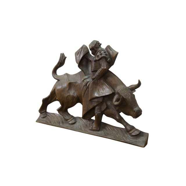 Vintage 20th century hand carved folk art style wall hanging relief depicting a Mexican bullfighter and bull in mid-...