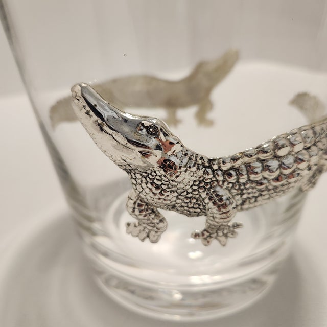 Bring a touch of vintage Hollywood Regency flair to your home bar with this striking alligator glass ice bucket. Perfect...