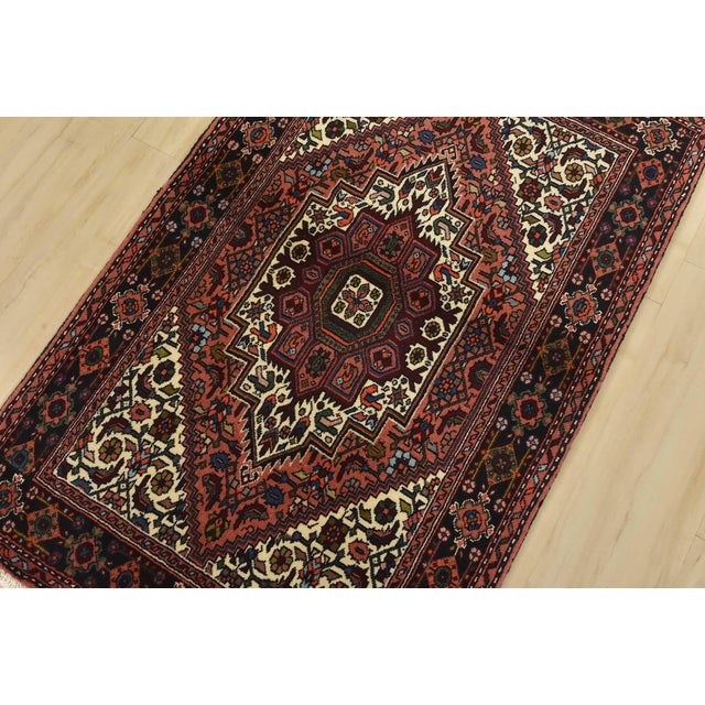 An authentic vintage traditional Goltogh rug hand-knotted with fine wool and natural dyes. This intricately woven rug...