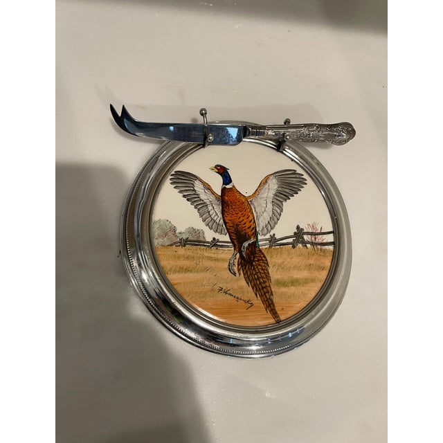 Nice, hand painted porcelain cheese plate with surrounding sterling silver rim. The rim has the sterling mark on the...