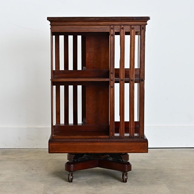A very practical and fun design, this square revolving bookcase would have been made in England circa 1870 using mahogany...