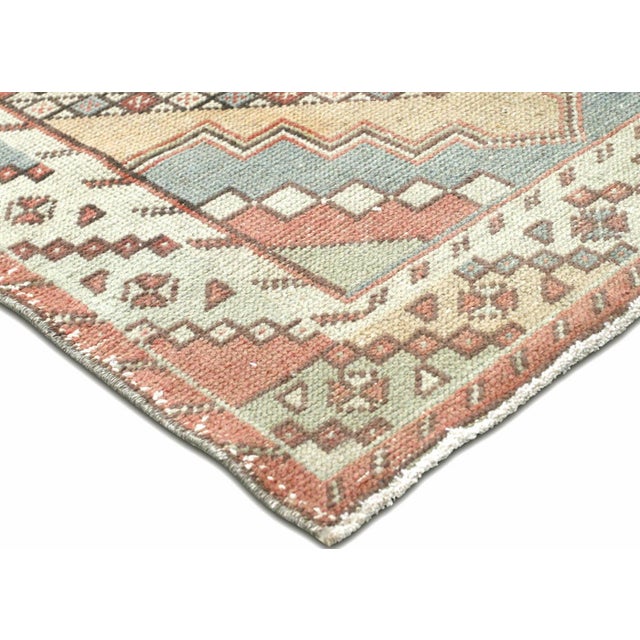 This vintage Turkish Oushak runner, handwoven with wool on a wool foundation in the Oushak region of Western Turkey,...