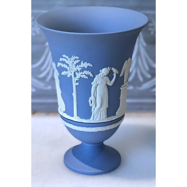 Stunning Wedgwood Blue Jasperware footed pedestal vase featuring the classic “Sacrifice” motif. This elegant 7 1/2-inch...