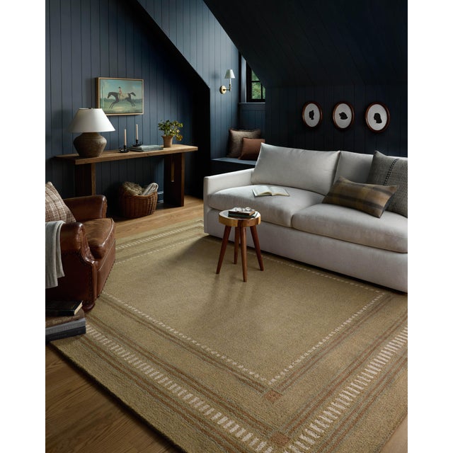 The Alfie Collection from Chris Loves Julia x Loloi is a handmade area rug with a playful framed design, a modern update...