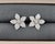 These stunning flower-shaped earrings feature 142 brilliant diamonds, totaling 1.48 carats. The diamonds are E/F in color...