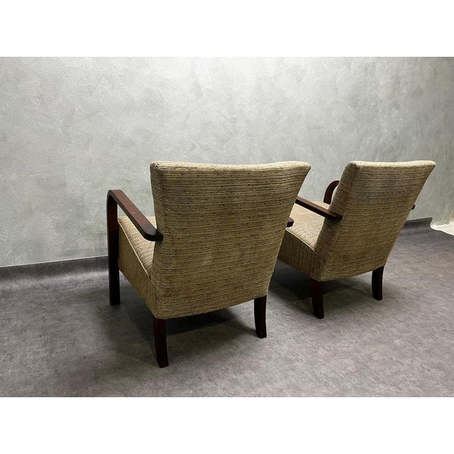 A pair of iconic h-213 armchairs from the first half of the 20th century, designed by jindřich halabala. Made of beech...