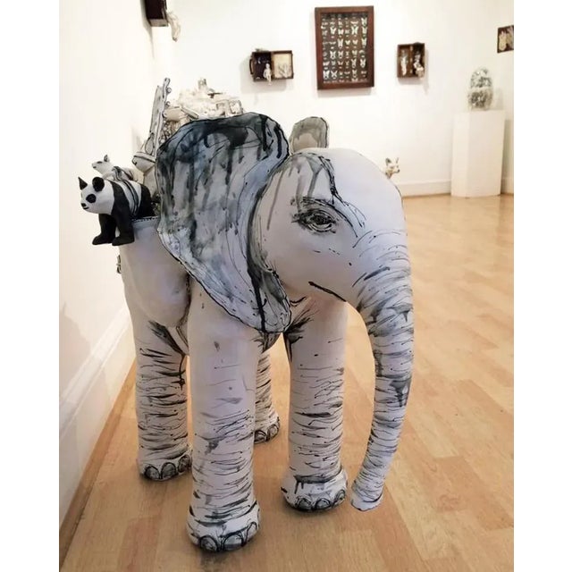 "elephant and friends”, by ceramic dynamo katharine morling is a porcelain free standing sculpture, depicting and engaging...