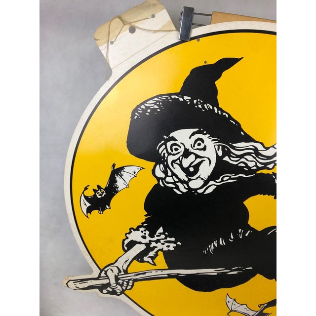 Vintage mid-century Halloween oversized flying witch cardboard die cut wall decoration featuring a classic witch soaring...