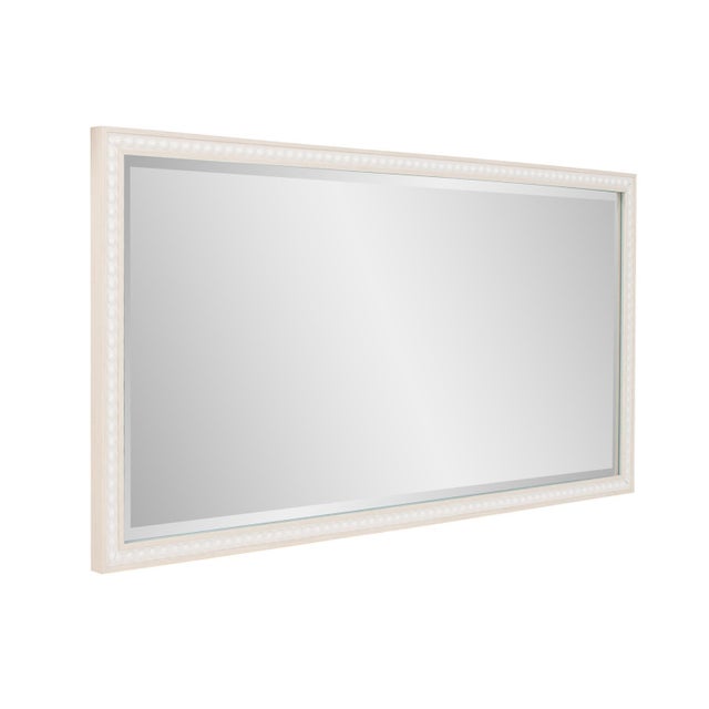 The Beaded Mirror features a timeless design with a delicate beaded border. Its neutral finish and sophisticated detailing...