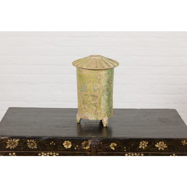 A 17th century Antique Chinese Granary Jar hand made from terracotta with a verdigris patina. Unearth an enthralling piece...