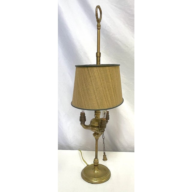 Very pretty antique converted three candle lamp. It is made of brass with a great aged patina and a height adjustable lamp...