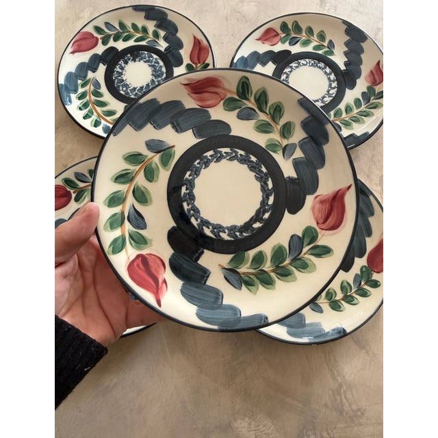 A beautifully cohesive set of five hand-painted studio pottery salad plates signed P. Silkotch and dated 1993. Created by...