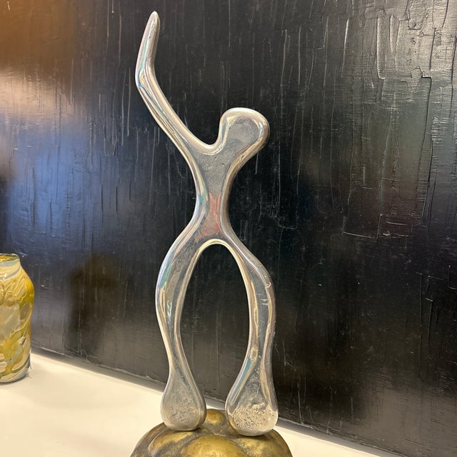 Silver metal sculpture on brass base that resembles a turtle shell. The sculpture is the same on both sides so the only...