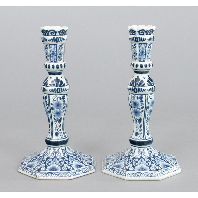 A lovely pair of Mid-Century Dutch Delft faience candlesticks. Maker's mark on reverse. These fine candlesticks are hand...