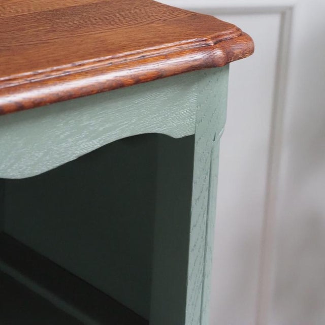 Open bookcase of French manufacture in the Louis XV style, crafted in oak, circa 1950-1970. The low, wide form is softened...