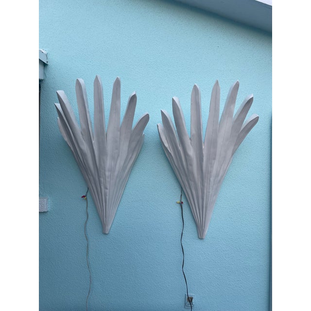 This pair of wall sconces, meticulously crafted from virgin plaster of Paris with internal steel reinforcement, is part of...