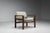 A striking mid-century lounge chair defined by its architectural cubic frame, crafted from solid wengé wood. The...
