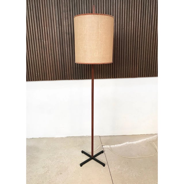 This minimalist high-quality floor lamp was manufactured in Germany during the early 1960s. It features a pole made from...
