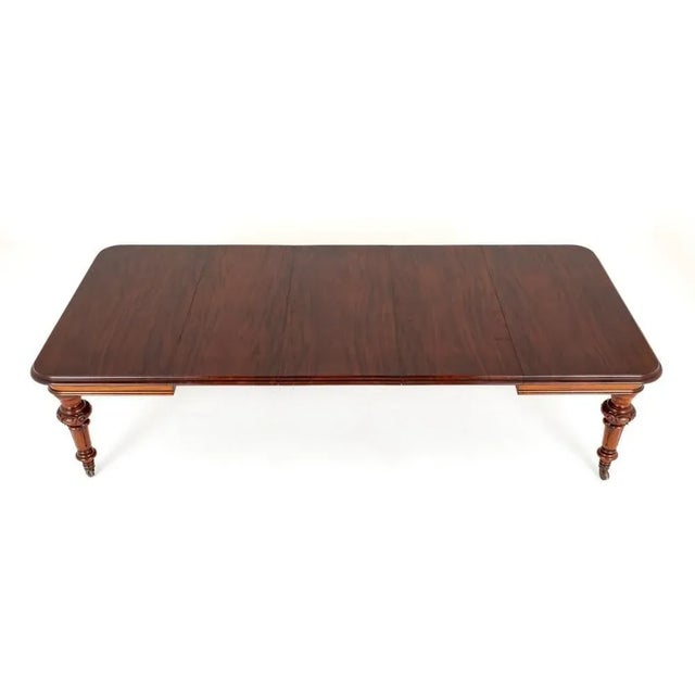 Good quality early Victorian mahogany extending dining table. Circa 1850. Standing upon turned and carved legs with...