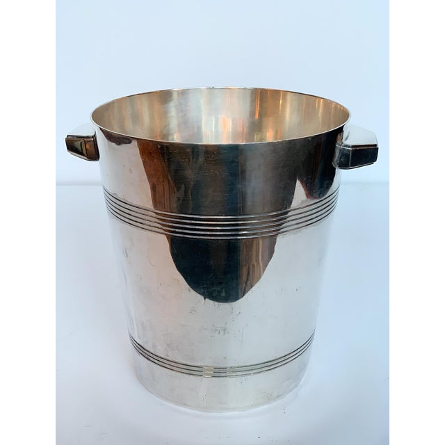This Art Deco silver-plated champagne or ice-bucket was produced by the Belgian silversmith company Wiskemann. It has been...