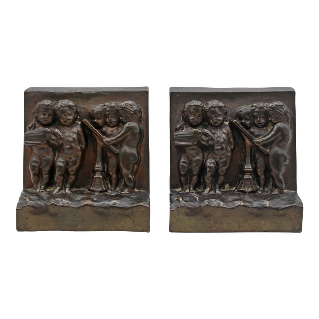 Circa 1900 Pair of Bronze Plated Bookends Featuring Reliefs of Putti For Sale