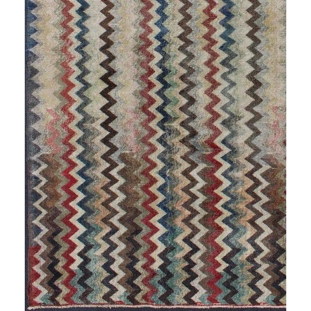Keivan Woven Arts. Rendered in zig-zag lines that run parallel to each other amidst an assortment of rich colors, this...