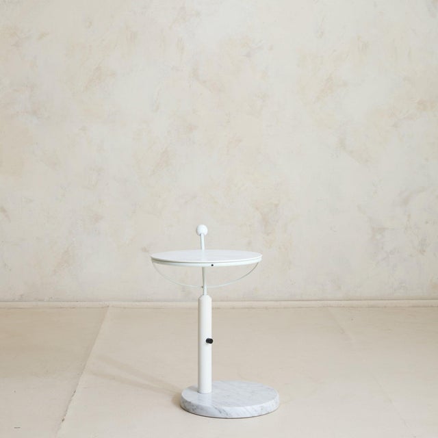 A French postmodern side table from the 1980s, composed of white metal with a solid marble base. Defined by clean geometry...