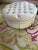 Custom white and green tufted ottoman by Vanguard. The lower portion of the sides of the ottoman are pleated. The white...