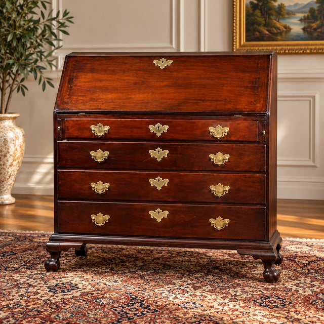 A handsome example of late 18th-century New England craftsmanship, this Chippendale slant front desk embodies the...