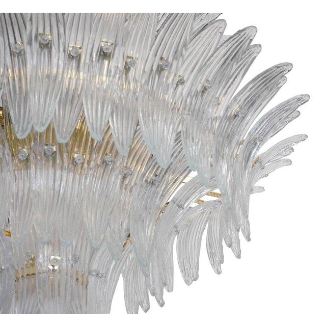 Italian Palmette chandelier with clear Murano glass leaves arranged on four tiers and mounted on gold-plated metal frame /...