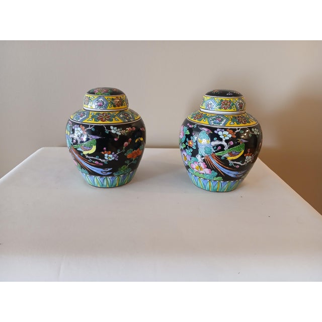 Cute Asian cloisonne twin small pots. Has a flower, bird, and geometric motif. Normal wear for age. Some chips of enamel....