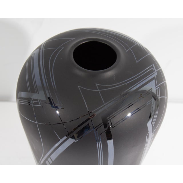 A 1989 art glass vase by the American glass artist Bob Toensing. Made of black glass, this vase features a geometric...